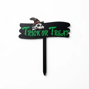 Halloween black acrylic cake topper detail showing the spooky skull and green text design.
