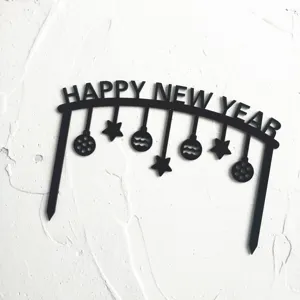 Black acrylic happy new year cake topper detail, minimalist arch holiday baking decoration.