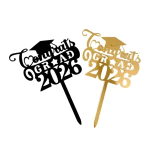 Close-up detail view of acrylic 2026 graduation cake topper in black and gold stylish finish.