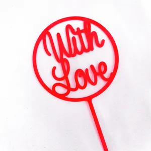 Red acrylic cake topper with With Love text for Valentine's Day party and romantic dessert decor.