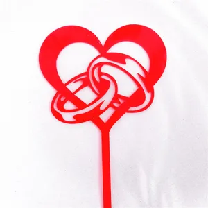 Red acrylic heart double rings cake topper detail view, wedding and Valentine decoration.