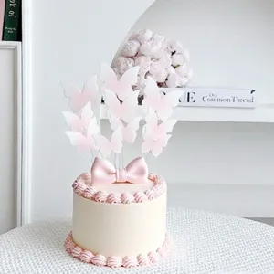 Délicats toppers de gâteau papillon rose avec nœud, parfaits pour table de dessert et fête.