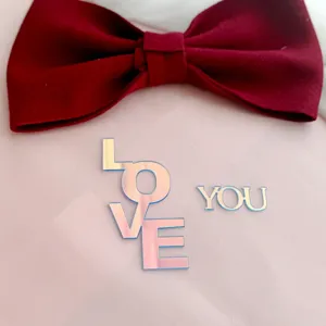 Holographic acrylic LOVE YOU cake topper with velvet bow, perfect for Valentine's Day party.