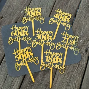 Gold acrylic happy birthday cake topper detail, showing numbers 18 to 70 for party decor.