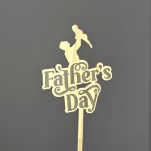 Gold acrylic Father's Day cake topper detail, featuring a loving silhouette and festive typography.
