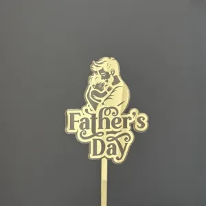 Gold acrylic Father's Day cake topper detail shot showing silhouette design and sleek finish.