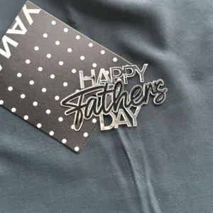 Father's Day acrylic cake topper detail shot, black and white polka dot backing card.