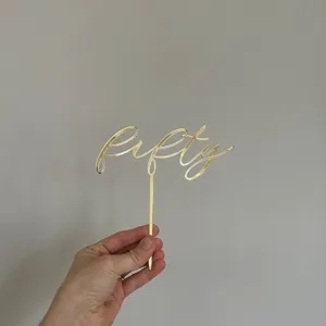 Gold acrylic fifty cake topper detail shot, perfect for birthday party or anniversary celebration.