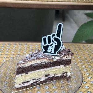 Details of the number one foam finger cake topper and layered cake slice for parties.