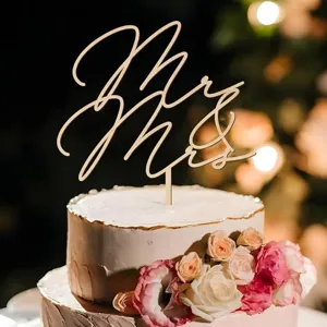 Wedding cake topper detail shot featuring a charming cursive Mr and Mrs wooden sign design.
