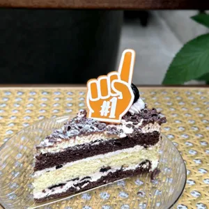 Detailed close-up view of an orange number one shape cake topper insert shown on a dessert.