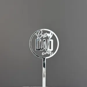 Detail view of silver acrylic Best Dad Ever cake topper for Father's Day party decorations.