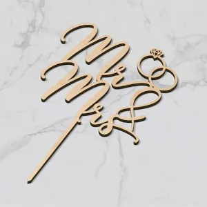 Detailed view of wooden Mr & Mrs wedding cake topper with ring design for party decor.