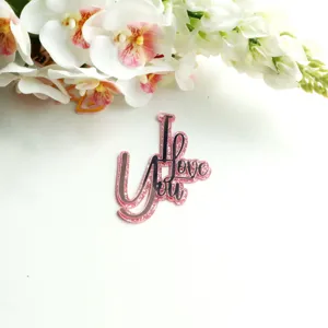 Pink glitter acrylic cake topper detail featuring sparkling pink finish and texture.