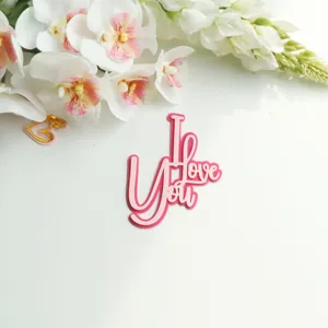 Pink acrylic I Love You cake topper detail view for Valentine's Day party decoration