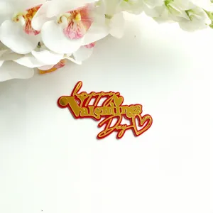 Close-up detail of double-layer red gold acrylic Valentine cake topper with heart.