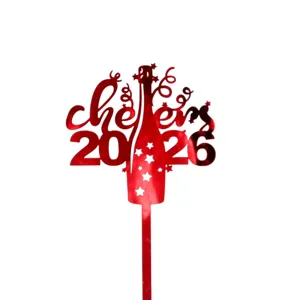 Red acrylic cheers 2026 cake topper detail, shiny reflective finish for New Year party dessert decor.