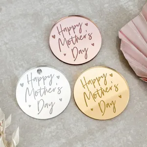 Detailed view of round acrylic Mother's Day decorative charms in gold, silver, and rose gold.