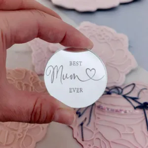 Detail view of clear acrylic MUM Mother's Day cake topper charm with elegant typography.