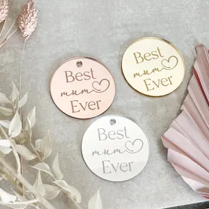 Acrylic circular cake topper engraved with Best mum Ever text, ideal for Mother's Day decor.