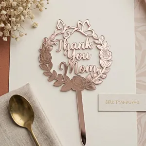 Mother's Day acrylic cake topper detail featuring floral butterfly wreath and elegant rose gold finish.