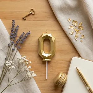 Gold geometric number 0 candle detail shot, perfect for birthday cake decoration and party styling.
