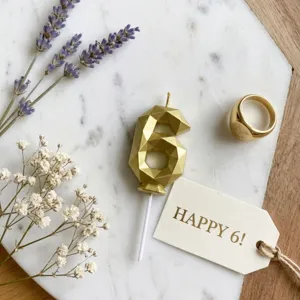 Gold geometric number 6 birthday cake candle detail view, perfect for party celebration decoration.