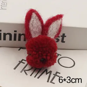 Handmade wool felt red rabbit head DIY accessory for phone case and brooch decoration.