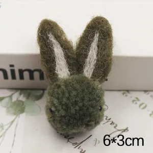 Wool felt rabbit head accessory, cute plush bunny ears detail for DIY phone case decor.