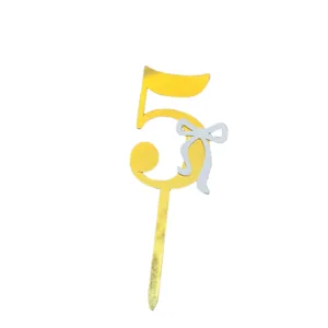 Acrylic number 5 cake topper detail, gold finish with elegant silver bow decoration.