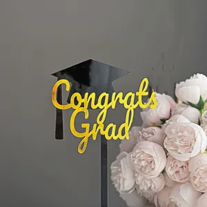 Acrylic graduation cake topper detail with black cap and gold Congrats Grad text!