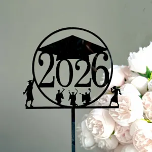 Close-up detail view of the black acrylic 2026 graduation cake topper with silhouette.