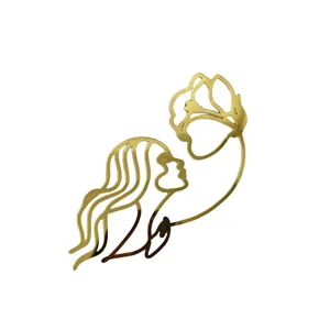 Gold acrylic face and flower cake topper, minimalist line art mirror finish cake decoration.