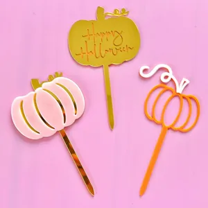 Halloween acrylic pumpkin cake topper detail view, decorative dessert party supplies.