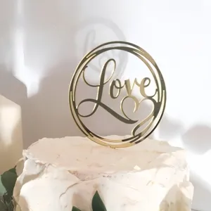 Gold acrylic cake topper with love heart design, perfect for wedding and party dessert decor.