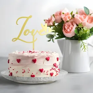 Acrylic gold Love cake topper set with heart decorations, perfect for dessert tables and parties.