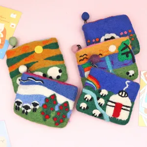 Handmade wool felt coin purse detailed view showcasing cute landscape and sheep design.