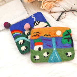 Handmade wool felt coin purse detail, cute sheep landscape pattern, cozy storage bag.