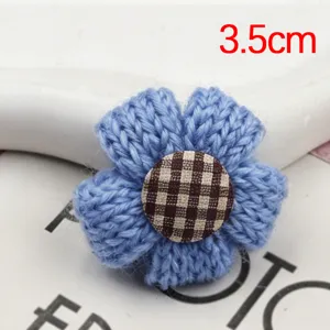 Handcrafted blue knitted flower accessory detail, cute fabric button center, 3.5cm size piece.