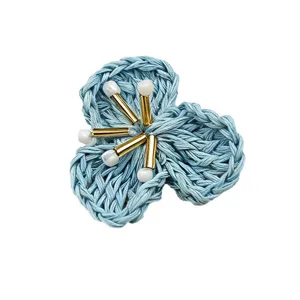 Handmade blue crochet flower DIY accessory with beaded pistils for hair and brooches.
