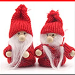 Close-up of cute Christmas gnome dolls with red knitted hats and white beards for home decor.
