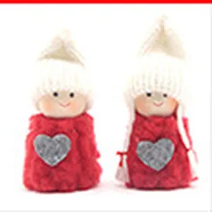 Cute Christmas plush doll detail, red and white design with heart patch, festive decor.
