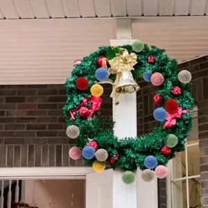 Handmade Christmas wreath with yarn balls, ideal for holiday tree hanging and home decor.