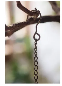 Detail shot of retro industrial style metal hanging chain and hook for garden bird feeders and decor.