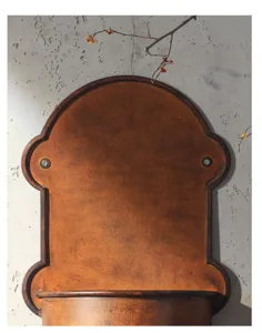 Detail shot of vintage rustic wall planter, antique brown metal wall hanging decor.