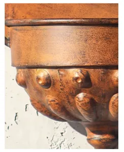 Close-up detail of retro distressed iron wall planter showing antique metallic embossed texture