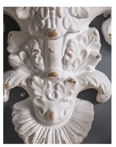 Close-up of vintage French white and gold embossed wall decor bracket detail texture.
