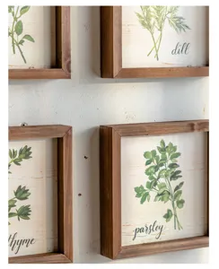 Detail shot of American country botanical framed wall art, rustic wooden frames with herb prints.