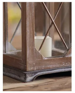 Detailed shot of rustic wooden candle lantern with glass panes and crossbars for home decor.