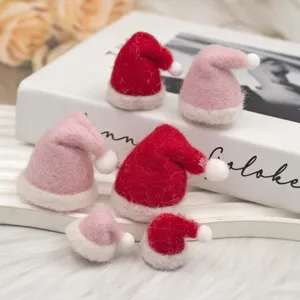 Miniature wool felt Santa hats closeup detail, red and pink DIY Christmas decoration props.